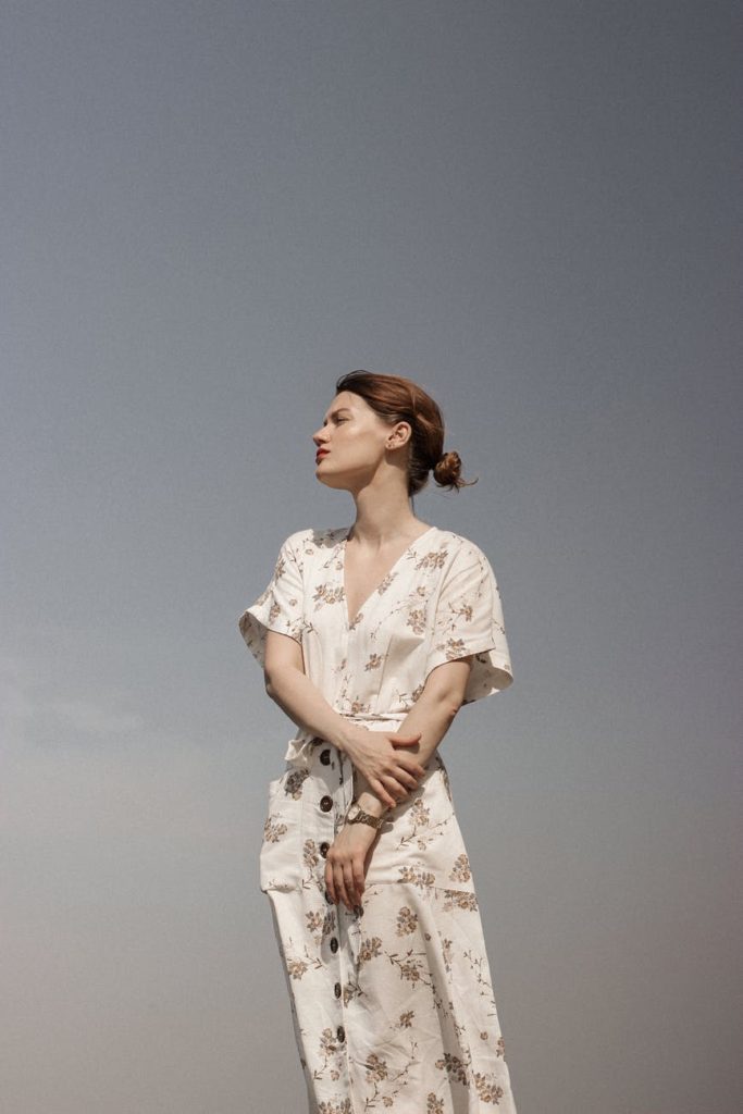 woman in white and brown floral dress
