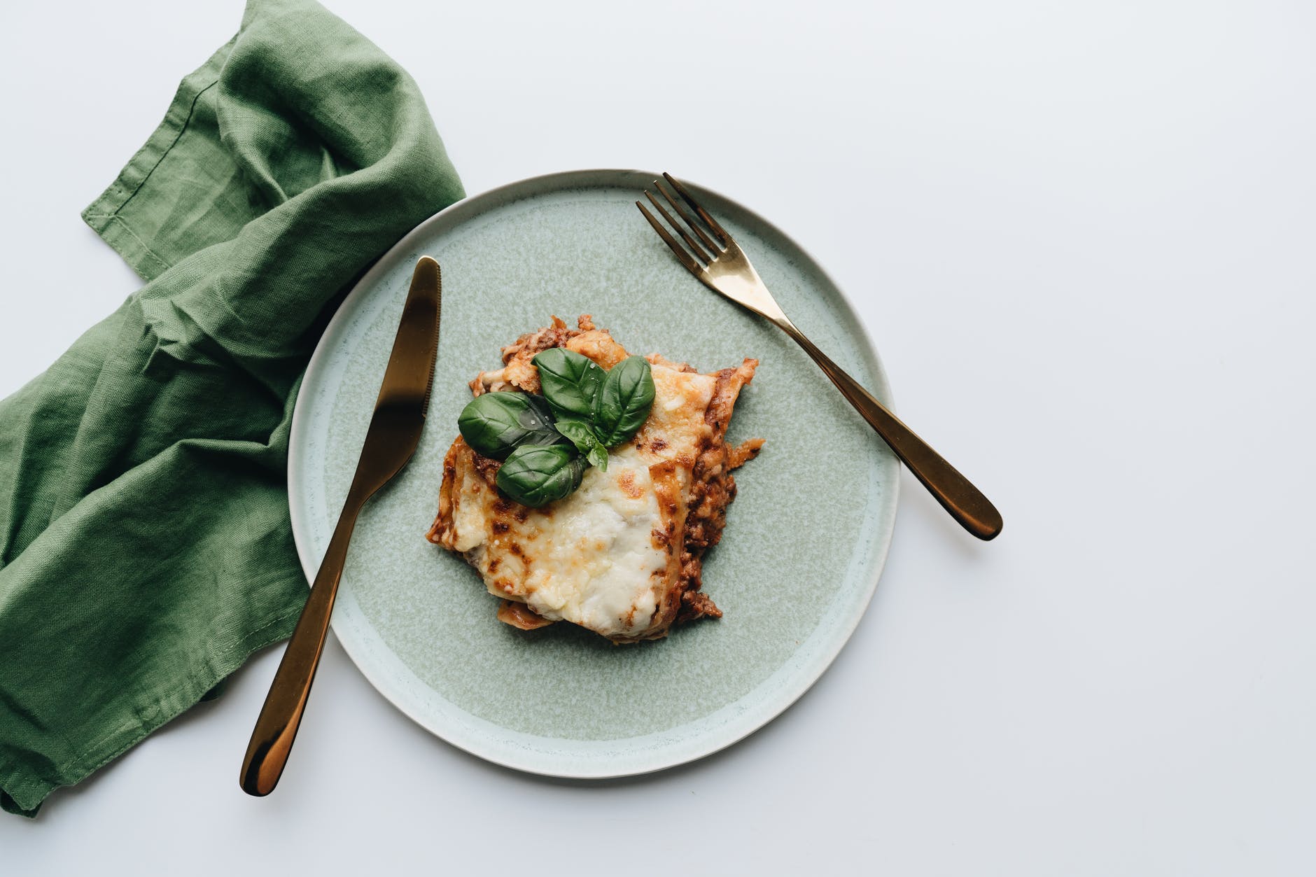 brown bread with green vegetable on white ceramic plate