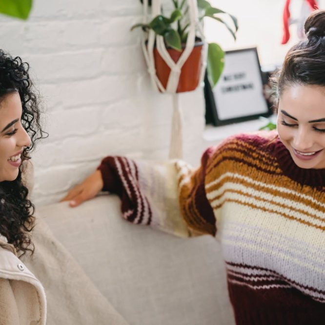 happy women talking in cozy room
