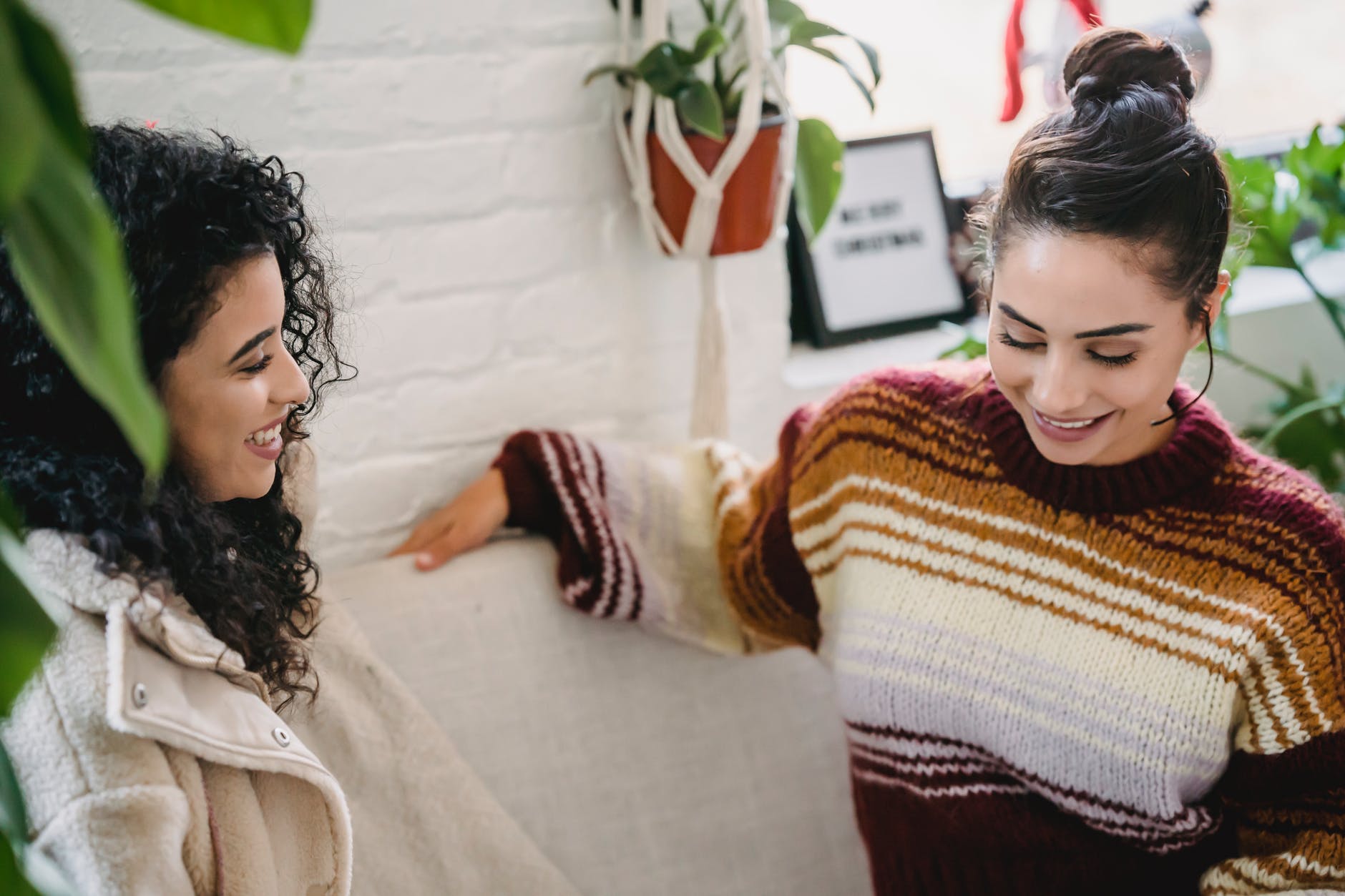 happy women talking in cozy room
